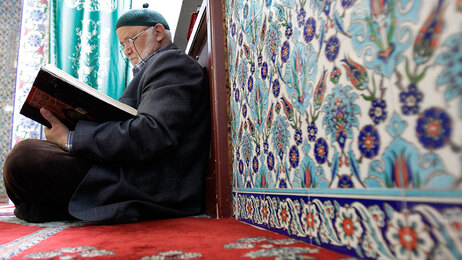 A man reads the Quran inside a mosque in Hamburg, northern Germany.