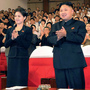 In this photo released by the Korean Central News Agency and distributed in Tokyo by the Korea News Service on July 9, North Korean leader Kim Jong Un is seen with a woman in Pyongyang. It's not clear who she is, but a first lady would be a marked departure from the days of Kim's father, who kept his personal life private.