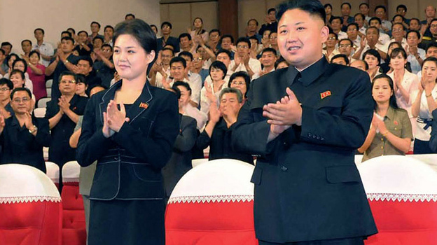 In this photo released by the Korean Central News Agency and distributed in Tokyo by the Korea News Service on July 9, North Korean leader Kim Jong Un is seen with a woman in Pyongyang. It's not clear who she is, but a first lady would be a marked departure from the days of Kim's father, who kept his personal life private.