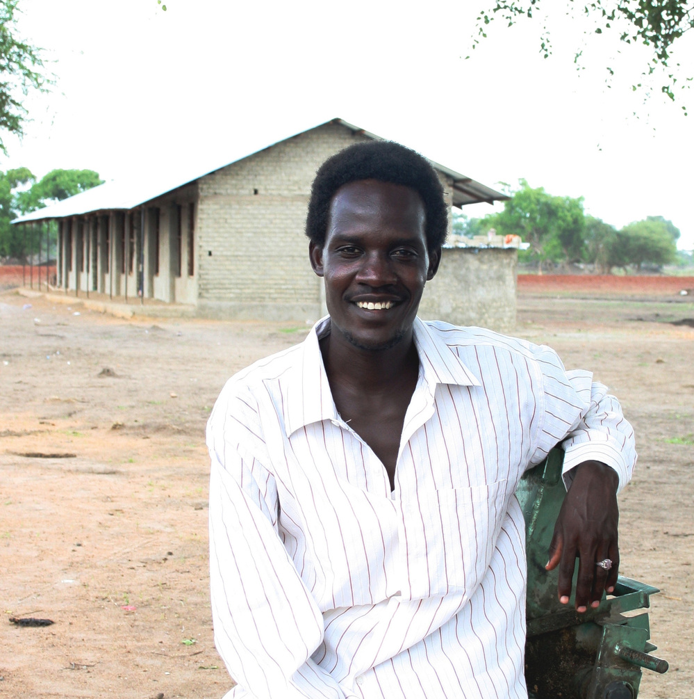 Rudwan Dawod stands in front of a school he helped build in Turalei, South Sudan. The Oregon resident is now detained in Sudan, accused of terrorism after he participated in protests there.
