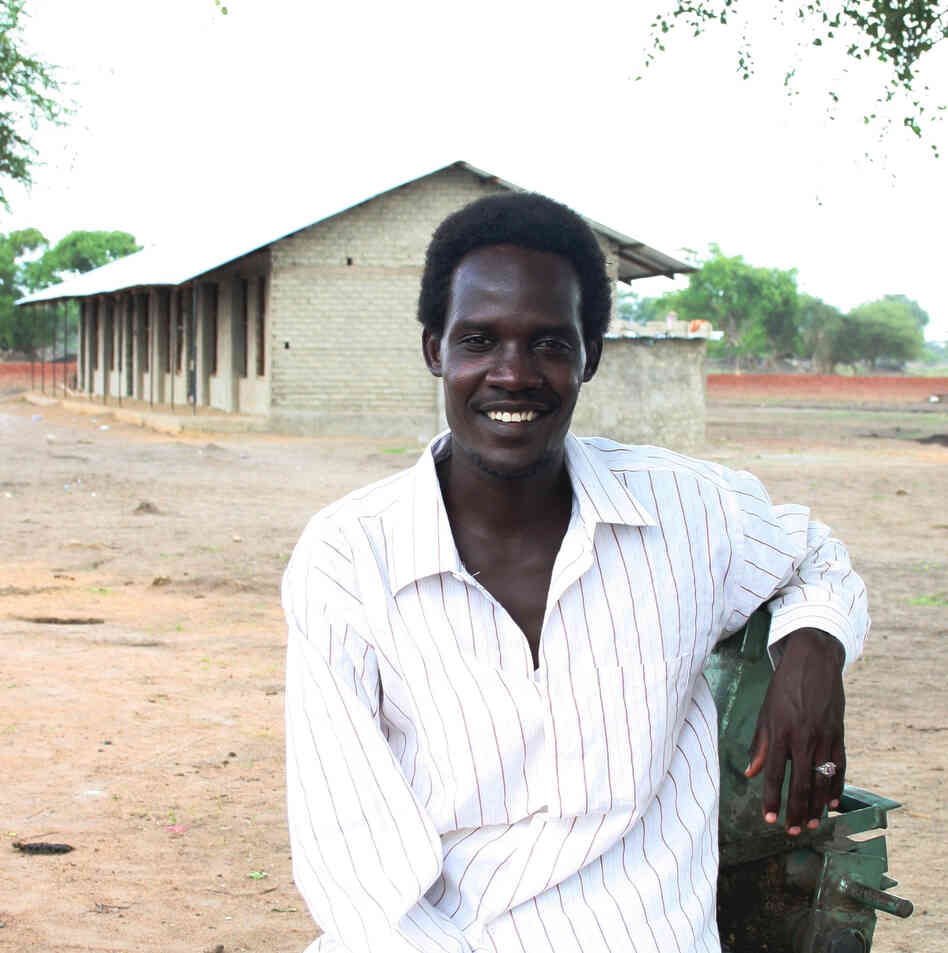 Rudwan Dawod stands in front of a school he helped build in Turalei, South Sudan. The Oregon resident is now detained in Sudan, accused of terrorism after he participated in protests there.