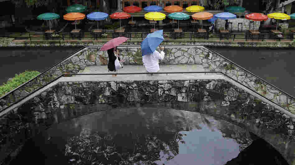 Pedestrians stand along the River Walk in San Antonio, Texas, in May. The state has gotten a reprieve from more than a year of drought.