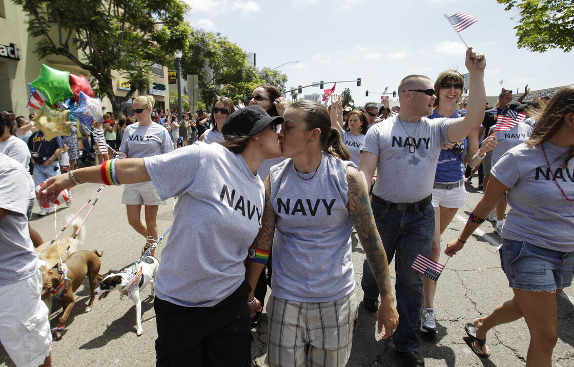 In this July 16, 2011 photo, two women, both active duty sailors in the Navy who gave their names as Nikki, left, and Lisa, kiss as they march in the Gay Pride Parade in San Diego.