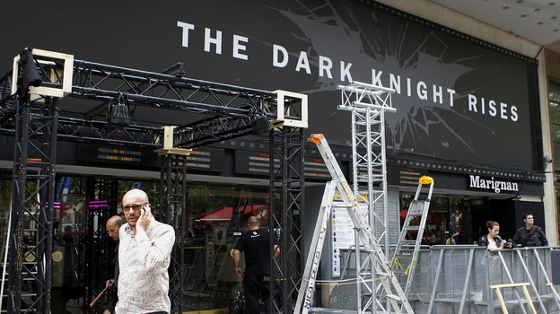 Workers dismantle an installation that was set up for the premiere of The Dark Knight Rises in Paris. It had been scheduled for Friday night but was canceled after a gunman killed 12 people at a Colorado opening of the same film.