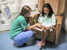 Child life specialist Kelly Schraf helps to put at ease Yoselyn Gaitan, 8, who had surgery on her cleft palate, at Children's National Medical Center in Washington, D.C. Child life specialist Kelly Schraf helps to put at ease Yoselyn Gaitan, 8, who had surgery on her cleft palate, at Children's National Medical Center in Washington, D.C.