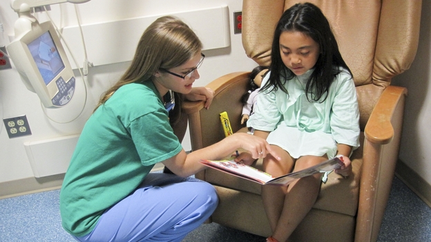 Child life specialist Kelly Schraf helps to put at ease Yoselyn Gaitan, 8, who had surgery on her cleft palate, at Children's National Medical Center in Washington, D.C.