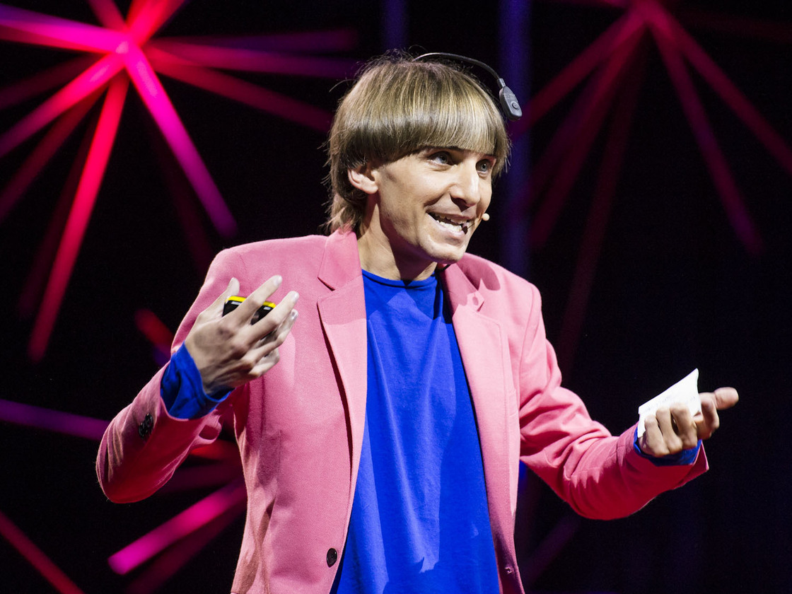 "Sonochromatic cyborg" and artist Neil Harbisson — with the implanted device that converts color to sound — at his TED talk in Edinburgh last month.