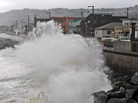 Waves pound a sea wall in Pacifica, Calif., during a storm in 2010. Small assumptions can make a big difference when putting a price-tag on future disasters.