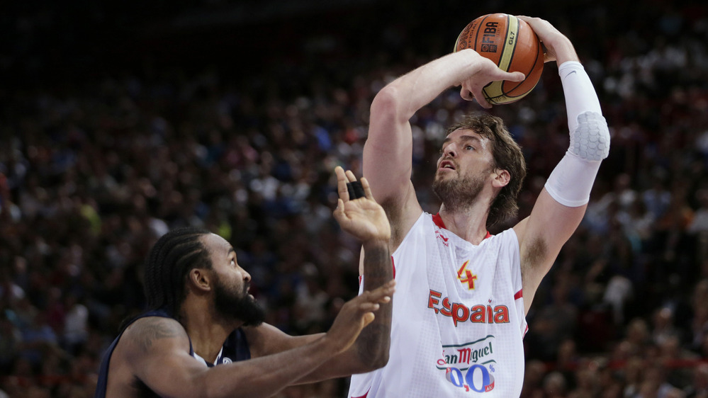 Spanish star Pau Gasol shoots over France's Ronny Turiaf during a pre-Olympic game earlier this month. Gasol, who regularly plays for the Los Angeles Lakers, was Spain's leading scorer in the 2008 Olympics, when the team won a silver medal. The Spaniards may have the best chance of upsetting the favored U.S. team at the London Olympics.