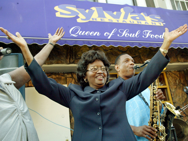Sylvia Woods moves to the music outside her restaurant in Harlem neighborhood of New York, during the restaurant's 40th anniversary celebration in 2002.