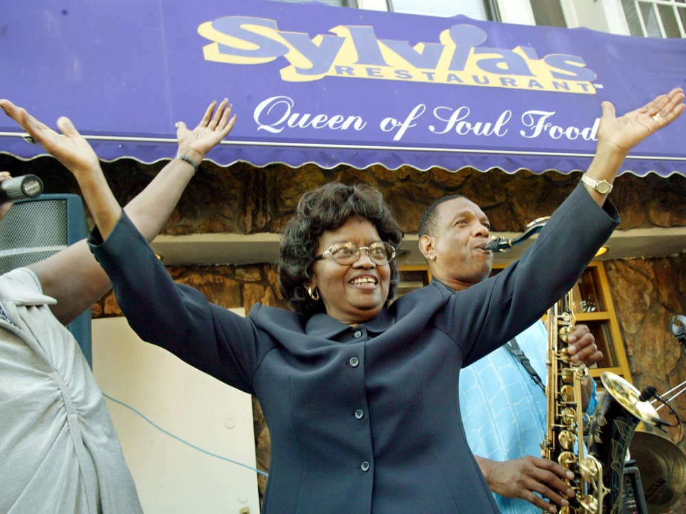 Sylvia Woods moves to the music outside her restaurant in Harlem neighborhood of New York, during the restaurant's 40th anniversary celebration in 2002.