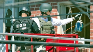 Bomb technicians used what one described to the Denver Post as a water bottle rigged with an explosive to destroy a "trip device" inside James Holmes' apartment.