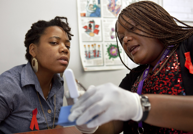 HIV counselor Natrussa Williams explains the results of the oral HIV test to Katherine Tapp at the D.C. Department of Motor Vehicles in southeast Washington. There have been no babies born with HIV in the city since 2009, in part because of increased testing at locations including some high schools and the DMV.