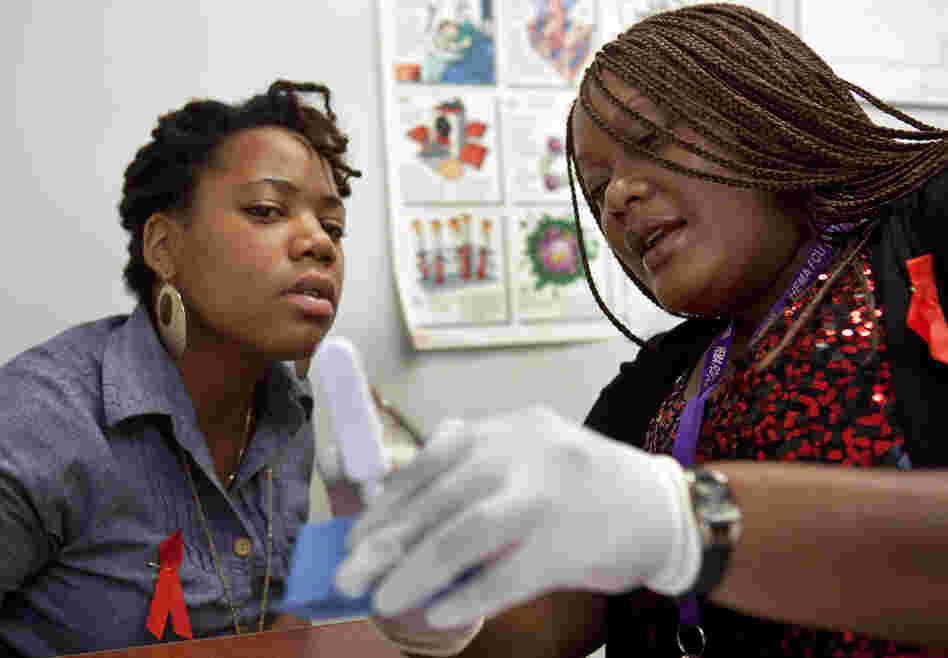 HIV counselor Natrussa Williams explains the results of the oral HIV test to Katherine Tapp at the D.C. Department of Motor Vehicles in southeast Washington. There have been no babies born with HIV in the city since 2009, in part because of increased testing at locations including some high schools and the DMV.