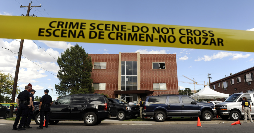 Police surround the apartment of James Holmes, the suspect in the Colorado theater shooting, on Friday in Aurora, Colo.