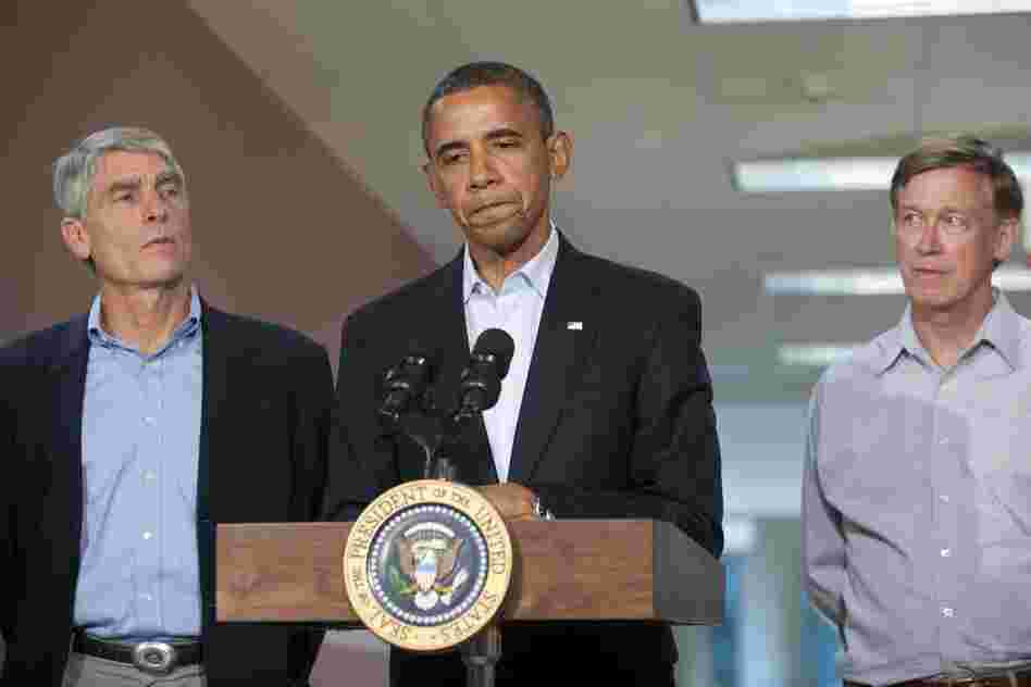 President Obama speaks alongside Colorado Sen. Mark Udall and Colorado Gov. John Hickenlooper (right) at the University of Colorado Hospital in Aurora on Sunday, following a visit with victims and family members.