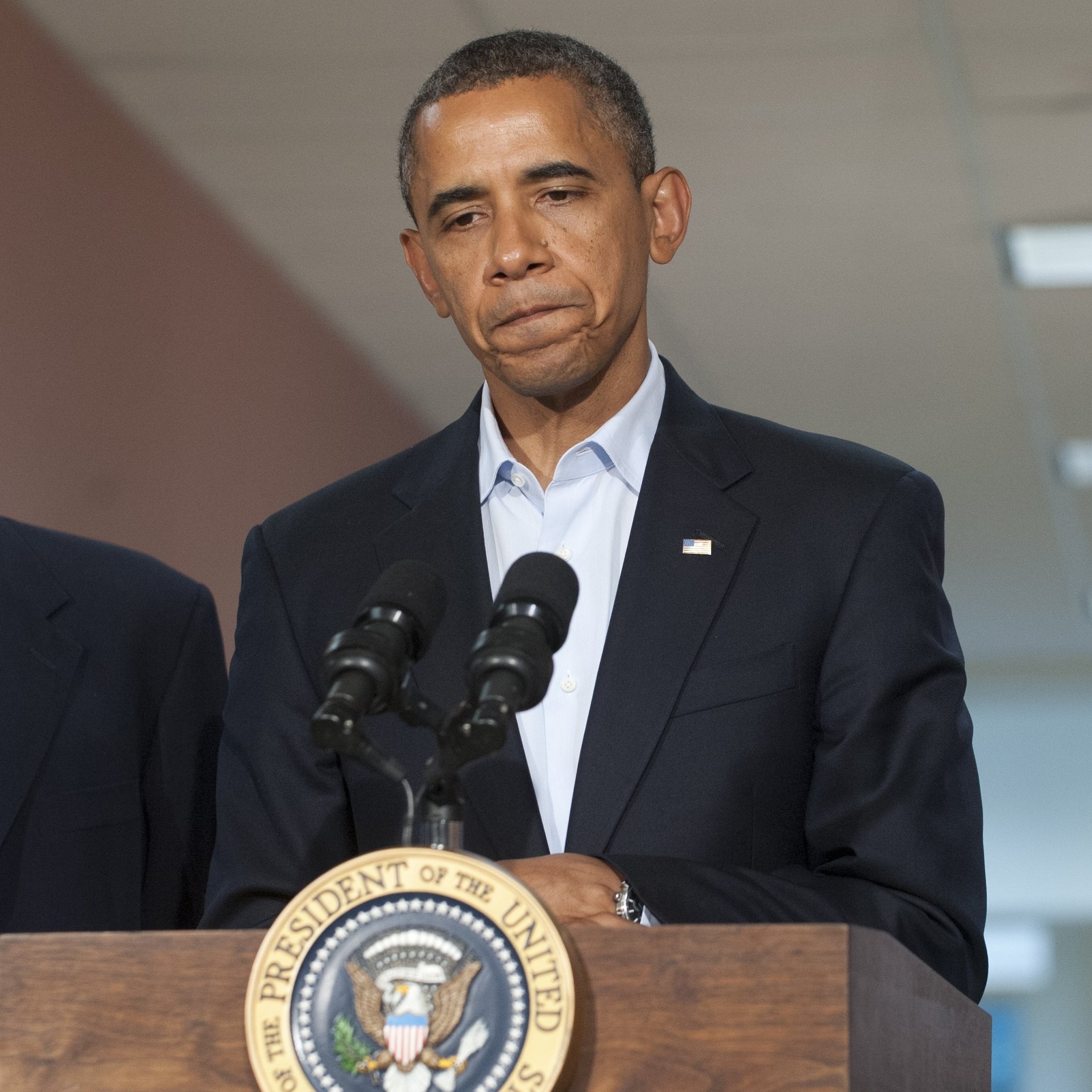President Obama speaks alongside Colorado Sen. Mark Udall and Colorado Gov. John Hickenlooper (right) at the University of Colorado Hospital in Aurora on Sunday, following a visit with victims and family members.