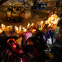 Mourners create a memorial at the fountain of the Aurora Municipal Center after a prayer vigil Sunday for the 12 victims of Friday's mass shooting at the Century 16 movie theater.