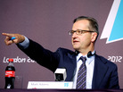 International Olympic Committee spokesman Mark Adams points to a reporter at a London news conference Saturday. The Olympic event may have been the first to have product placement. International Olympic Committee spokesman Mark Adams points to a reporter at a London news conference Saturday. The Olympic event may have been the first to have product placement.