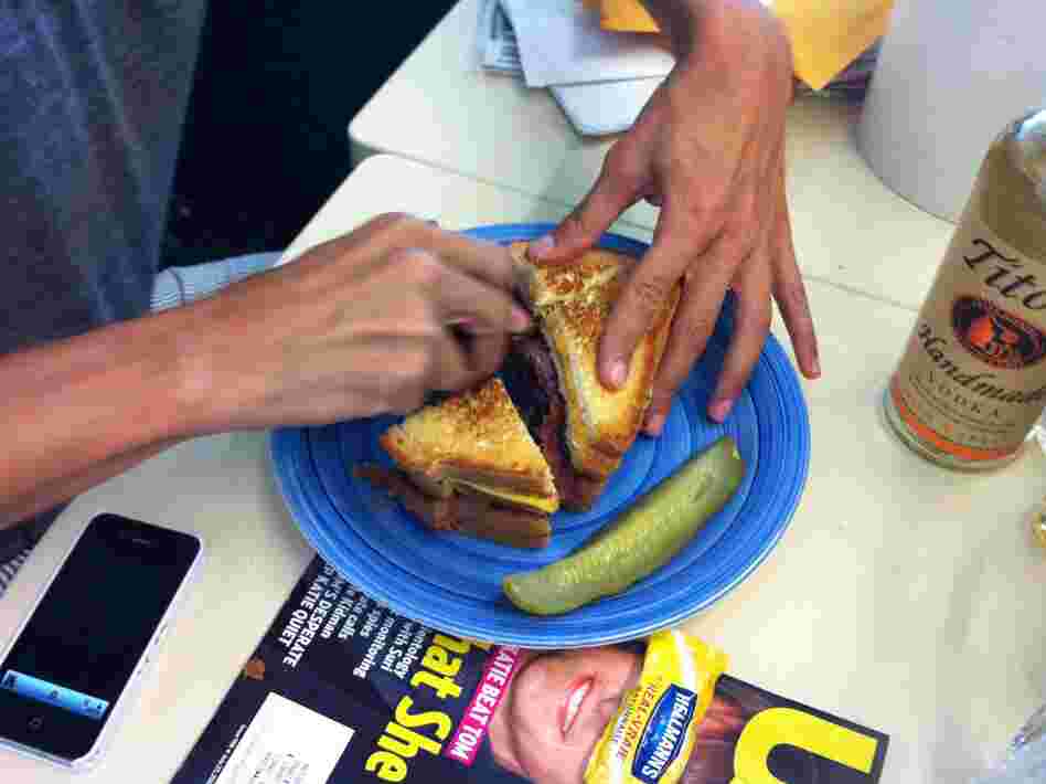 Ian cuts the sandwich into five healthy 1000 calorie bites.