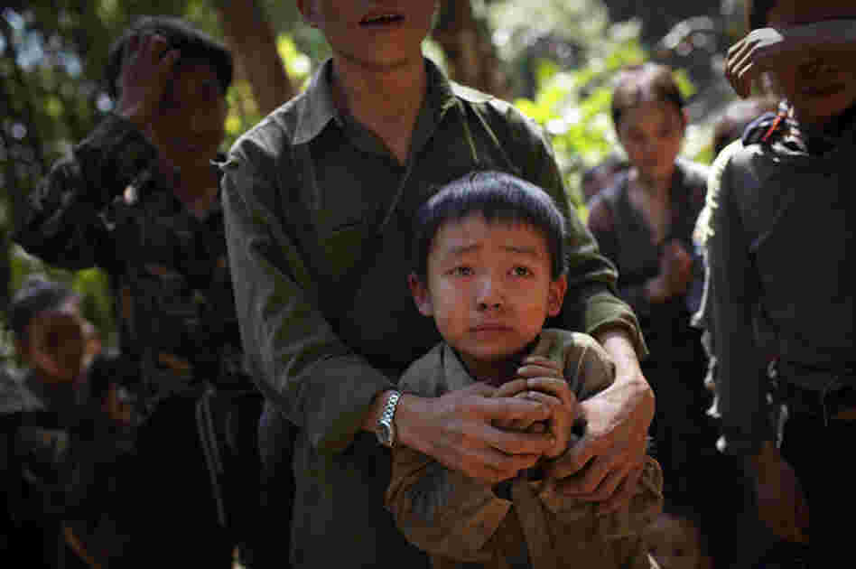 Hmong villagers break down in tears at their hidden village in Laos on Nov. 27, 2007. The villagers are regular targets of the Lao People's Army for their roles in collaborating with the CIA during the Vietnam War. Their families have had limited contact with Westerners since 1975.