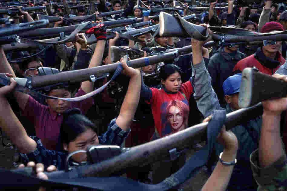 A Maoist rebel soldier in a Britney Spears T-shirt stands with soldiers of the People's Liberation Army during a drill in a schoolyard in the village of Gairigaon, Nepal, February 2005.