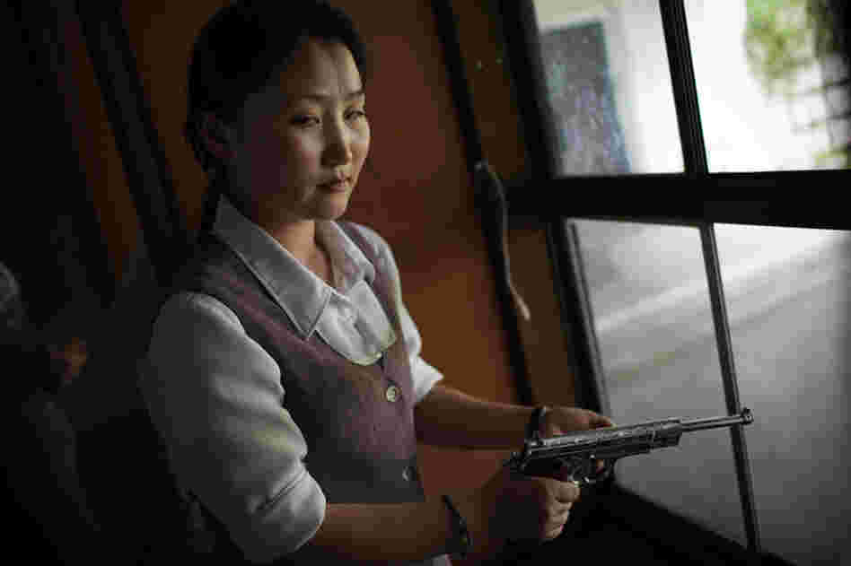 A North Korean woman loads a pistol for firing practice in Pyongyang, North Korea, August 2007.