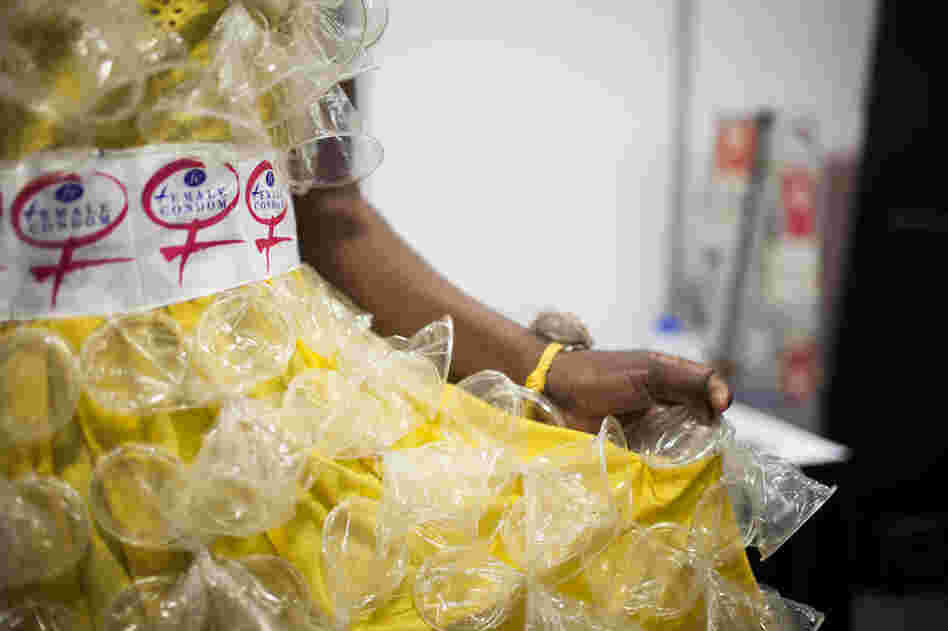 Olwin Manyanye shows off her dress decorated with the latest type of female condom, called "FC2." These second-generation condoms went on the market in 2009. They're more comfortable and increased the popularity and demand for this method of contraception method.