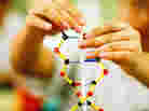hands playing with DNA hands playing with DNA