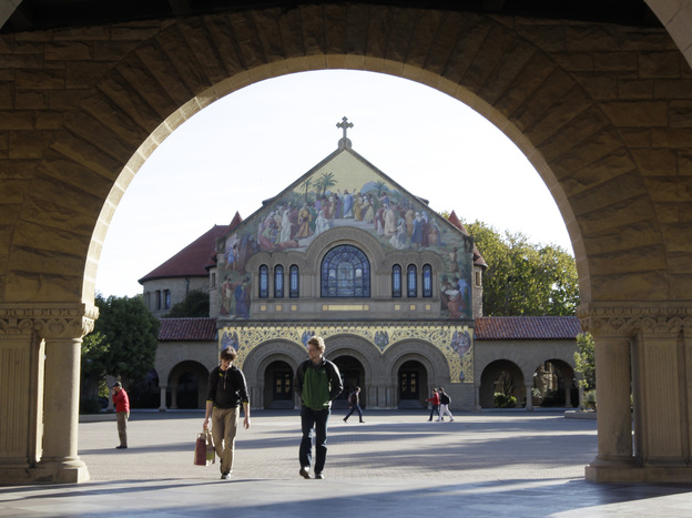 Two students walk in front of Stanford Memorial Church on the Stanford University campus in Stanford, Calif.