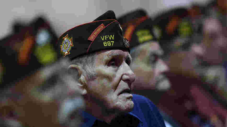 Members of the Veterans of Foreign Wars look on Monday as President Obama speaks during the group's national convention in Reno, Nev. Republican Mitt Romney was scheduled to speak to the group on Tuesday.