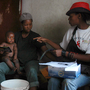 Health care workers in South Africa speak to residents during a door-to-door AIDS awareness campaign, part of a series of prevention efforts that has helped lower the country's HIV infection rate.