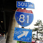 A sign for Interstate 81 sits under an overpass in Syracuse, N.Y. City officials and residents are debating what to do about an aging stretch of the highway that cuts through the city.