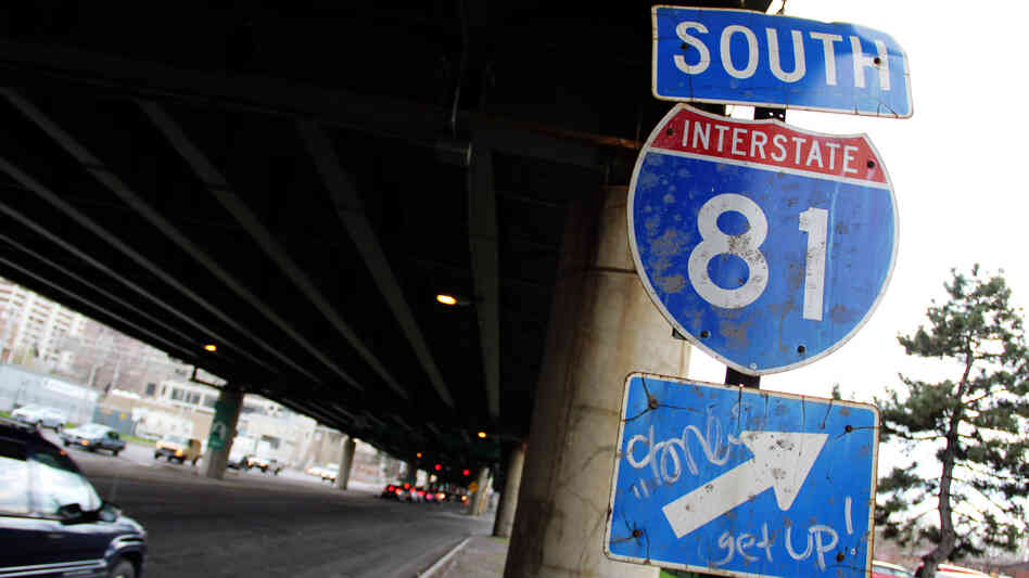 A sign for Interstate 81 sits under an overpass in Syracuse, N.Y. City officials and residents are debating what to do about an aging stretch of the highway that cuts through the city.