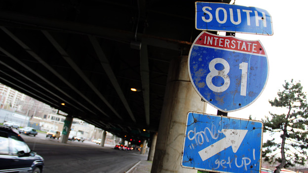 A sign for Interstate 81 sits under an overpass in Syracuse, N.Y. City officials and residents are debating what to do about an aging stretch of the highway that cuts through the city. A sign for Interstate 81 sits under an overpass in Syracuse, N.Y. City officials and residents are debating what to do about an aging stretch of the highway that cuts through the city.