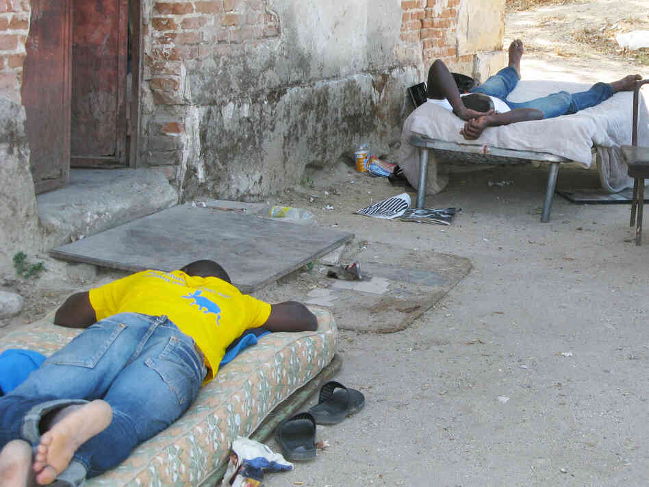 Men on cots wait for farm work near Calabria. Poor living conditions for migrant workers, sometimes without running water or toilet facilities, has led the Italian government to set up tents for them. Men on cots wait for farm work near Calabria. Poor living conditions for migrant workers, sometimes without running water or toilet facilities, has led the Italian government to set up tents for them.