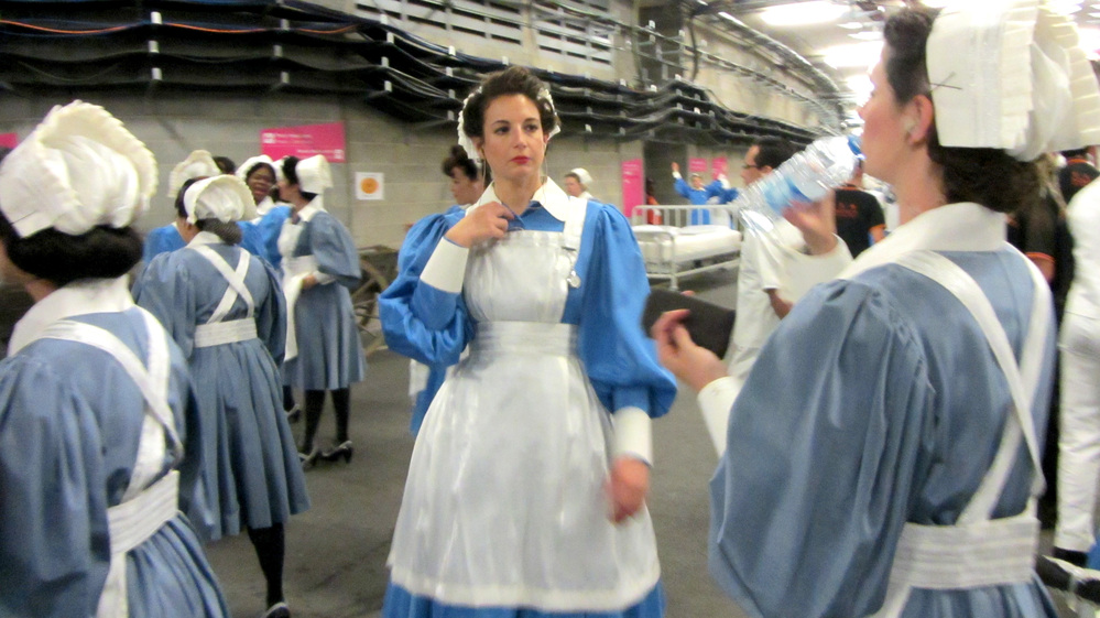March of the Nurses: A group of performers waits to rehearse their role in the Olympics Opening Ceremony Friday.