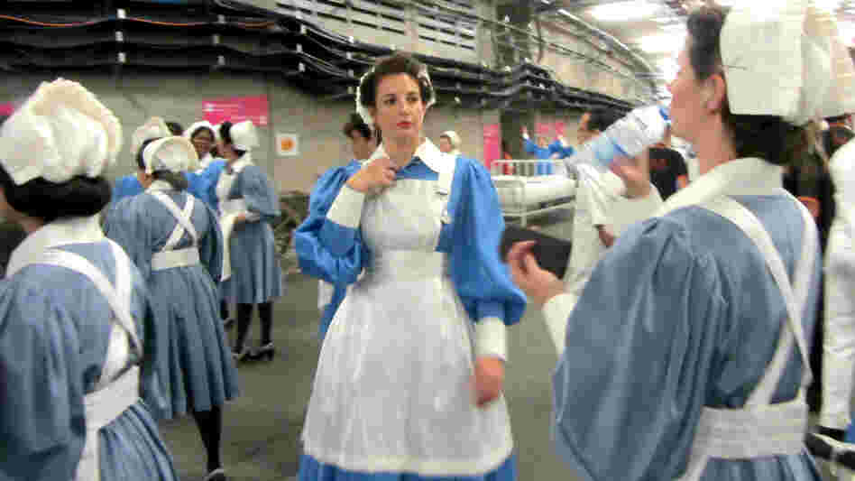 March of the Nurses: A group of performers waits to rehearse their role in the Olympics Opening Ceremony Friday.