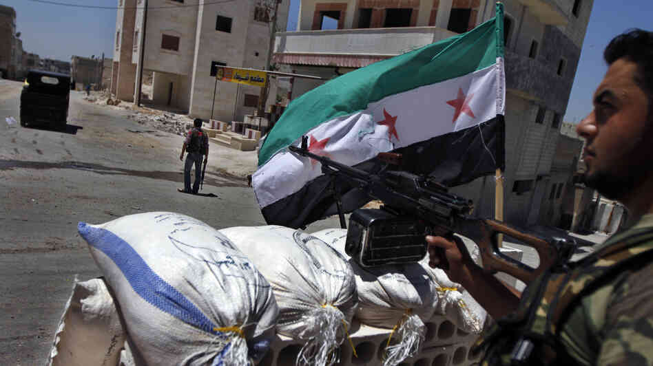 A Free Syrian Army solider mans a checkpoint in the northern town of Ariha, on the outskirts of Idlib, Syria, last month. In rural areas held by rebels, new institutions are cropping up to fill the void left by the receding Syrian state.