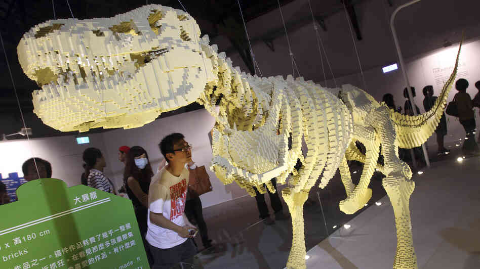 A visitor looks at artist Nathan Sawaya's Lego sculpture "T-Rax" at "The Art of the Brick" exhibition in Taiwan earlier this month.