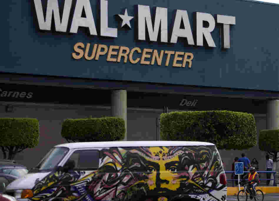 A van covered by a mural sits parked outside a Walt-Mart Super Center in Mexico City.