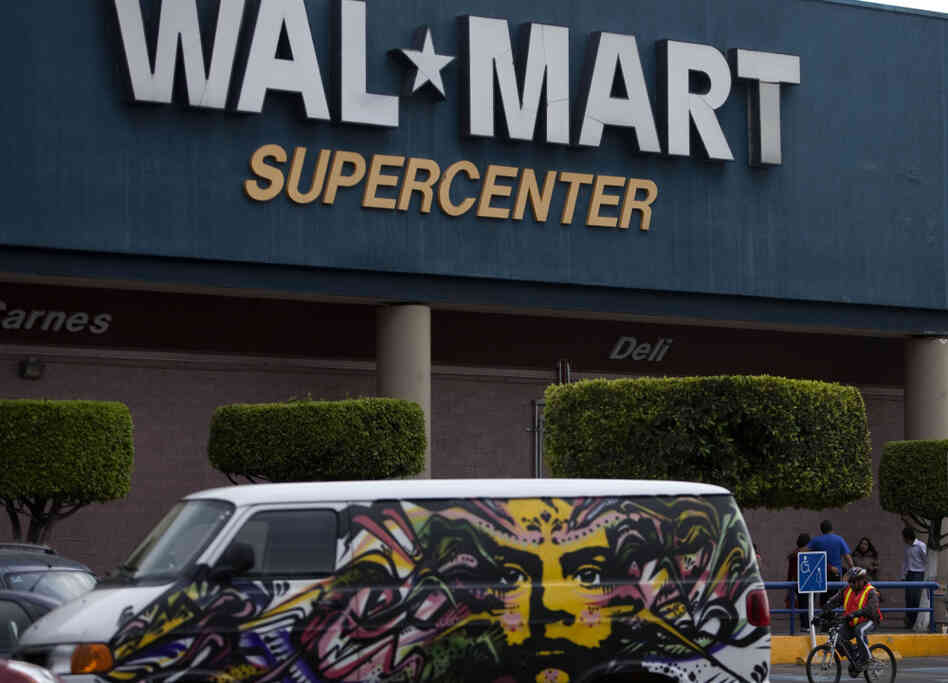 A van covered by a mural sits parked outside a Walt-Mart Super Center in Mexico City.