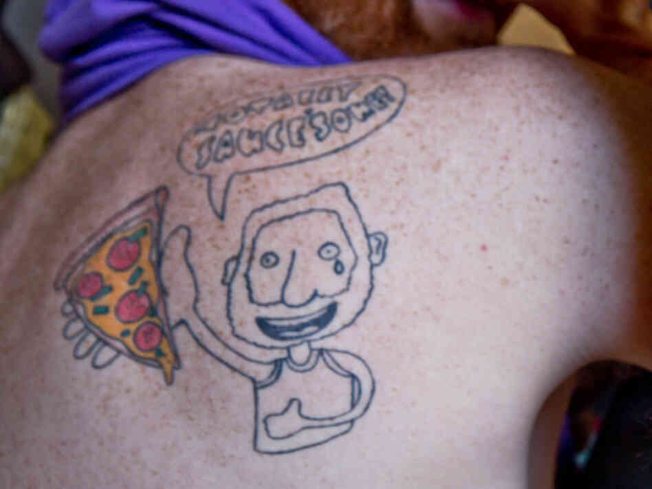 Dwyer branded himself with a tattoo of himself holding a slice.
