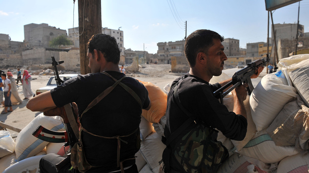 Tuesday in Aleppo, these men from an anti-Assad force were on guard at a checkpoint.