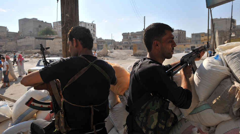 Tuesday in Aleppo, these men from an anti-Assad force were on guard at a checkpoint.