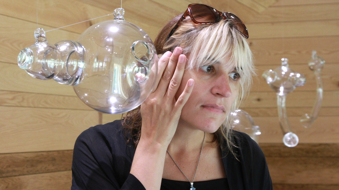 Artist Andrea Polli listens to modified bat sounds through a glass vessel inspired by Helmholtz resonators at the Marsh-Billings-Rockefeller National Historic Park in Woodstock, Vt.