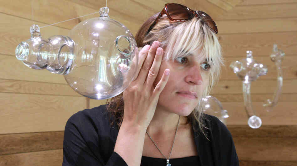 Artist Andrea Polli listens to modified bat sounds through a glass vessel inspired by Helmholtz resonators at the Marsh-Billings-Rockefeller National Historic Park in Woodstock, Vt.