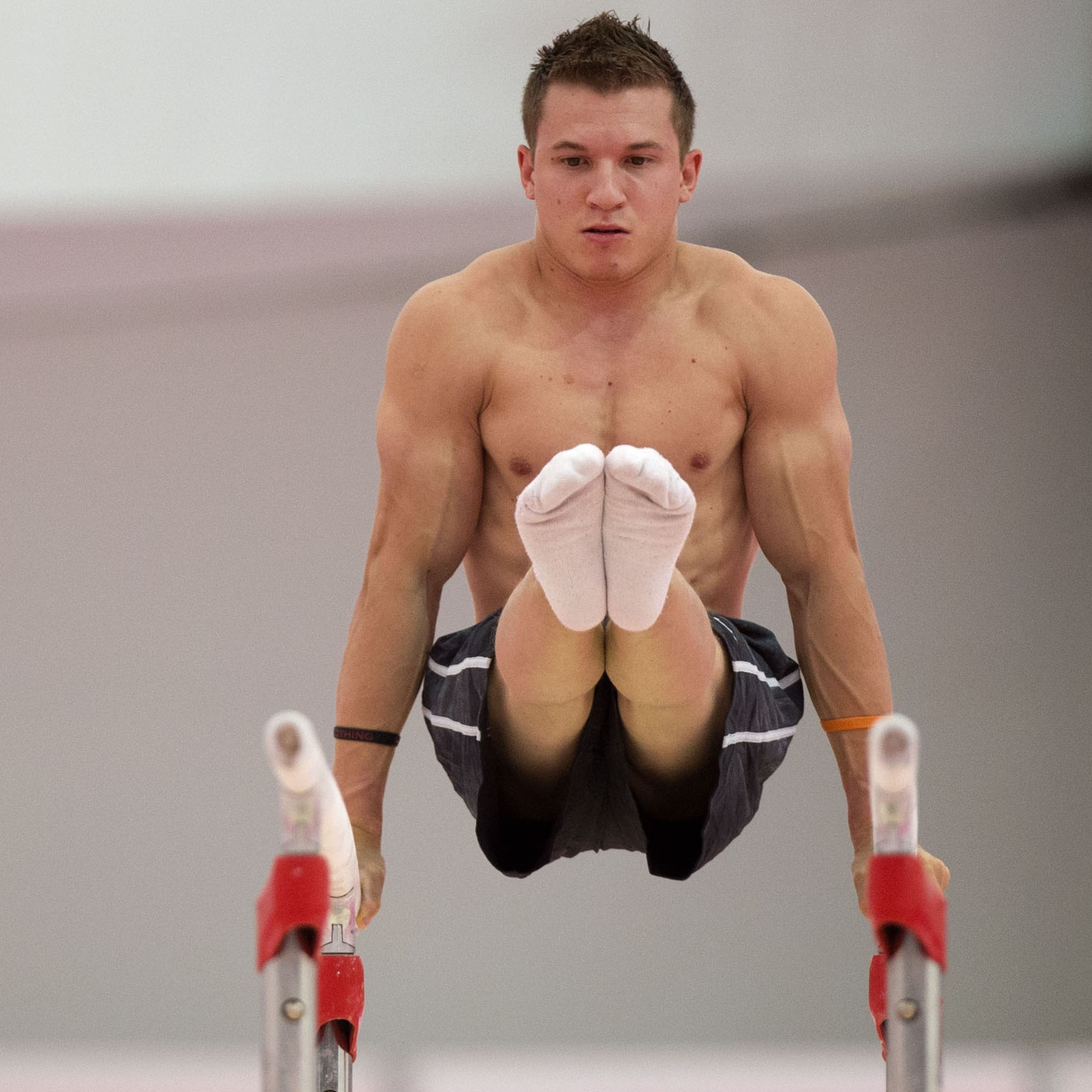 U.S. gymnast Jonathan Horton warming up on the parallel bars  in a practice arena ahead of the 2012 Summer Olympics.