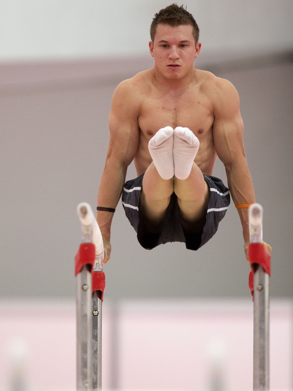 U.S. gymnast Jonathan Horton warming up on the parallel bars  in a practice arena ahead of the 2012 Summer Olympics.