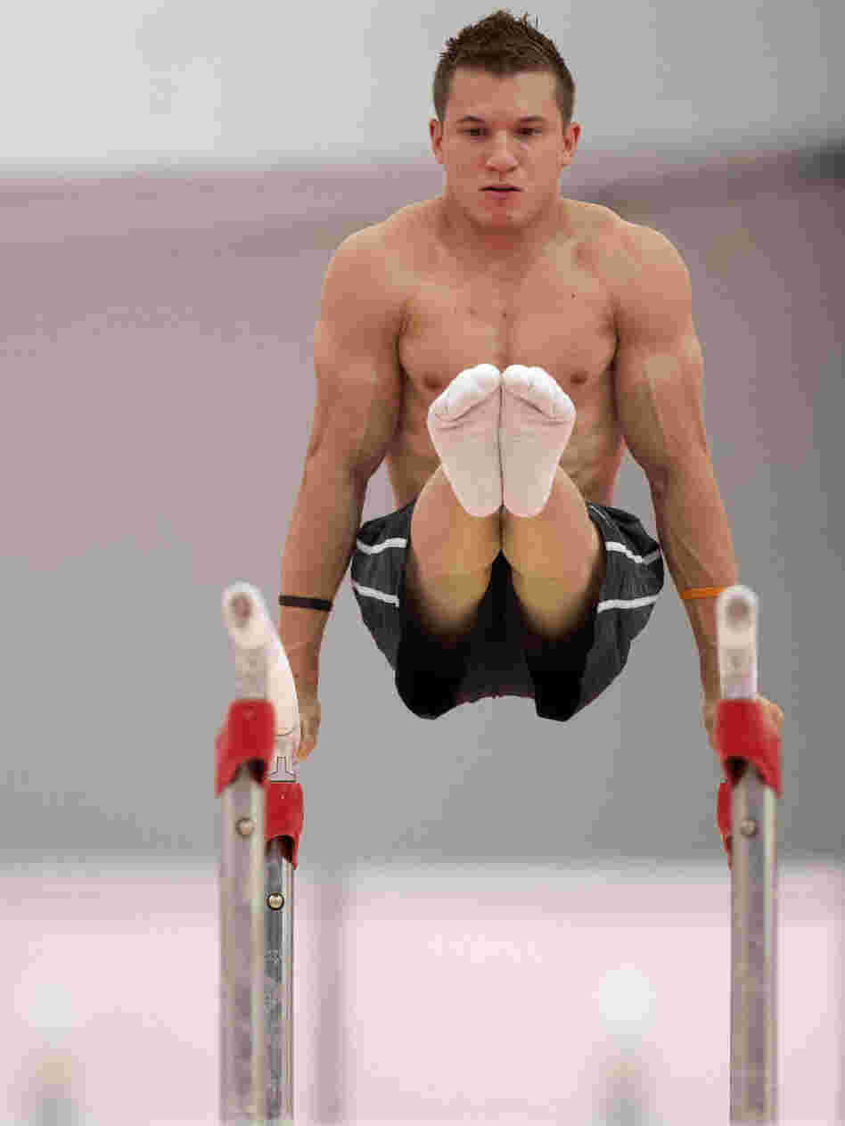 U.S. gymnast Jonathan Horton warming up on the parallel bars  in a practice arena ahead of the 2012 Summer Olympics.